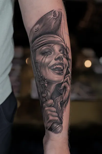 High-contrast black and grey character tattoo