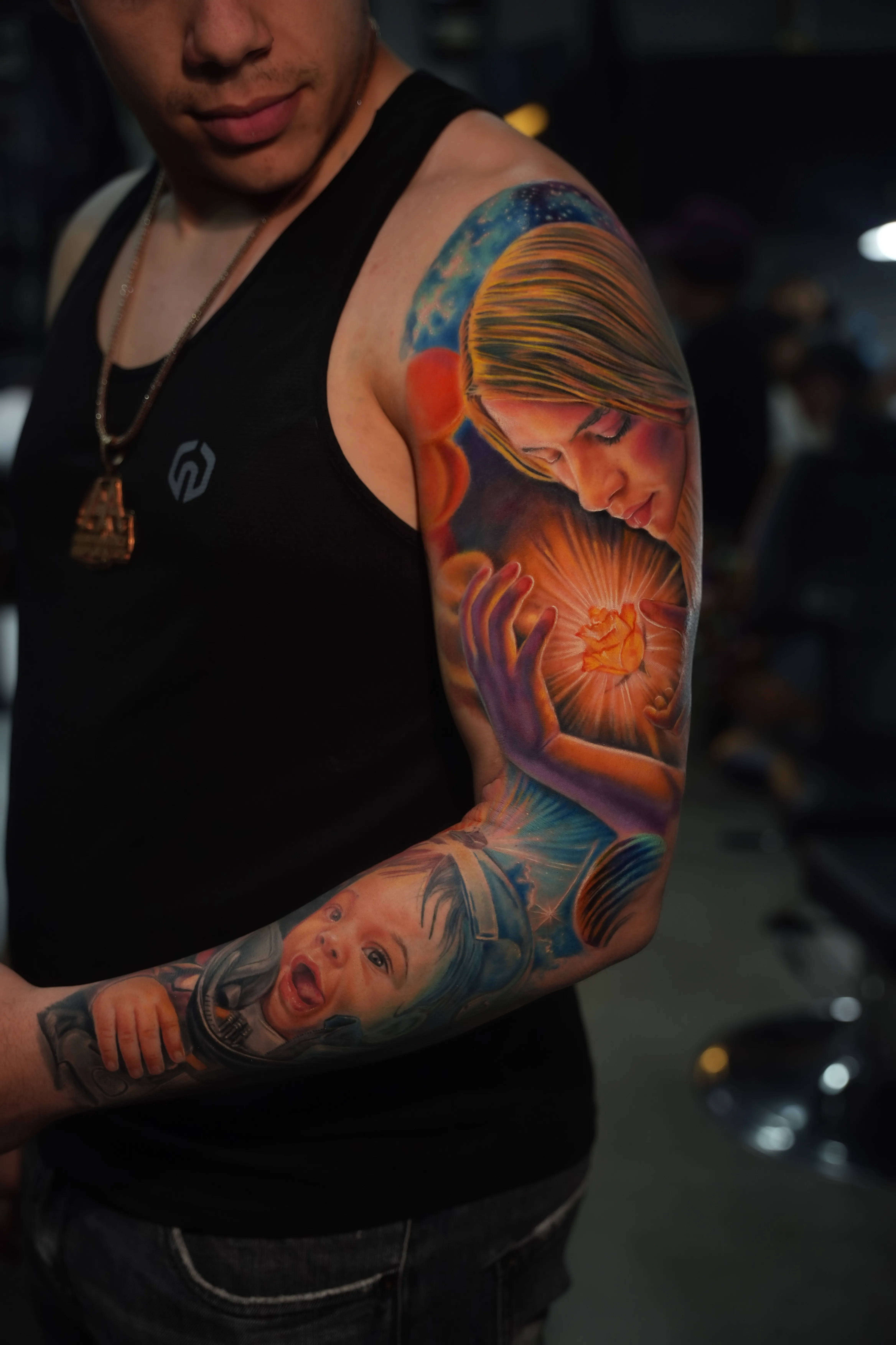 TKO Tattoo color realism sleeve — woman cradling a glowing rose over a cosmic sky